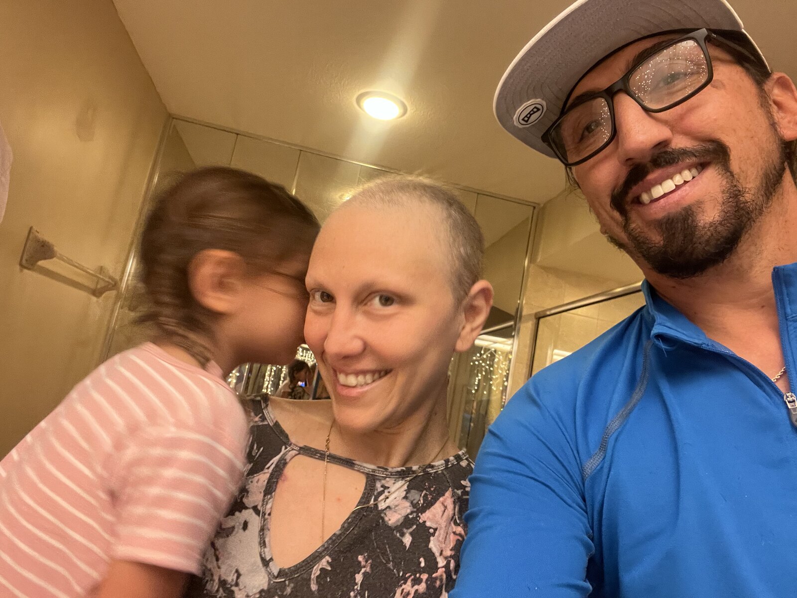 During chemotherapy, holding my daughter, with my husband beside us