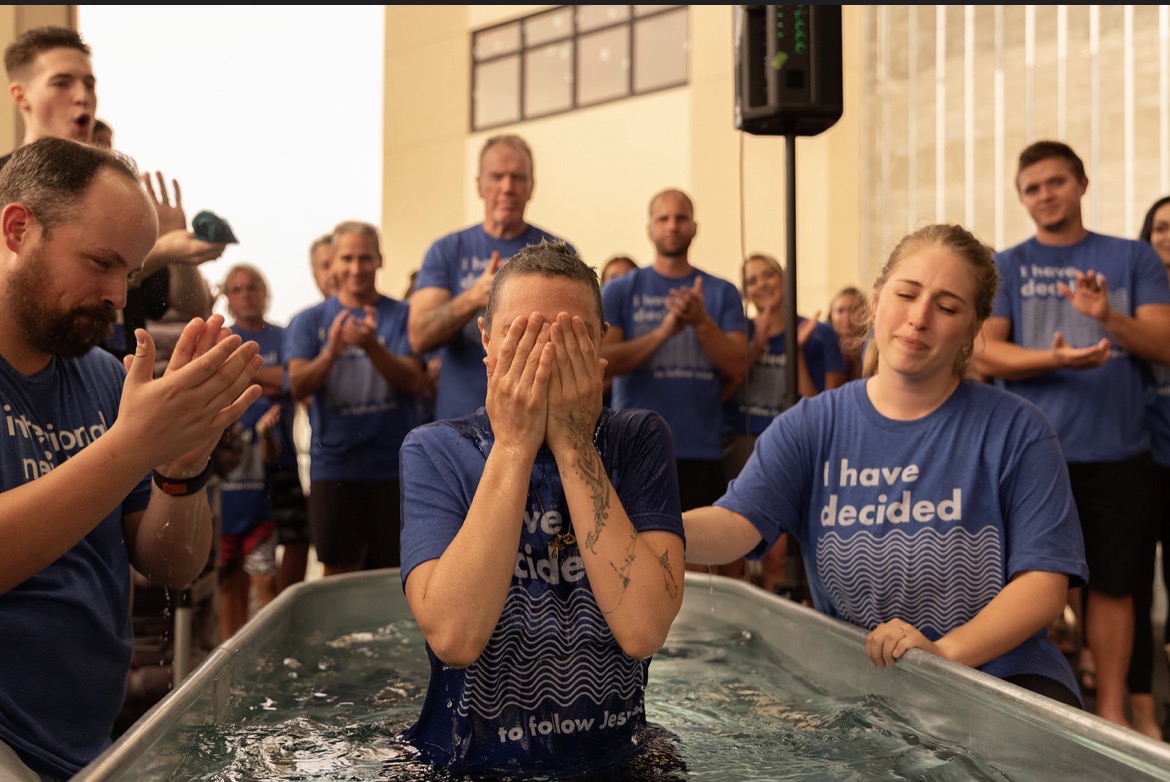 Covering my face in tears as the church claps after my baptism