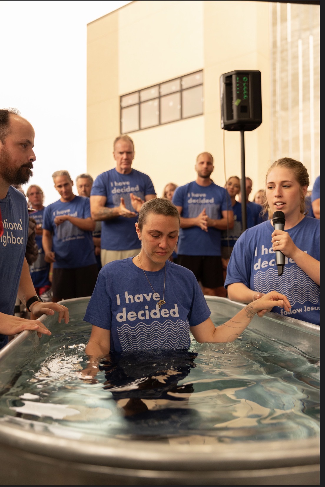 Standing in the baptism tank as a friend prays over me