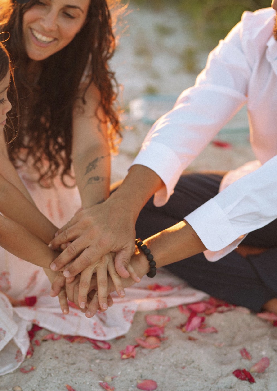 Adelina and her family with their hands together
