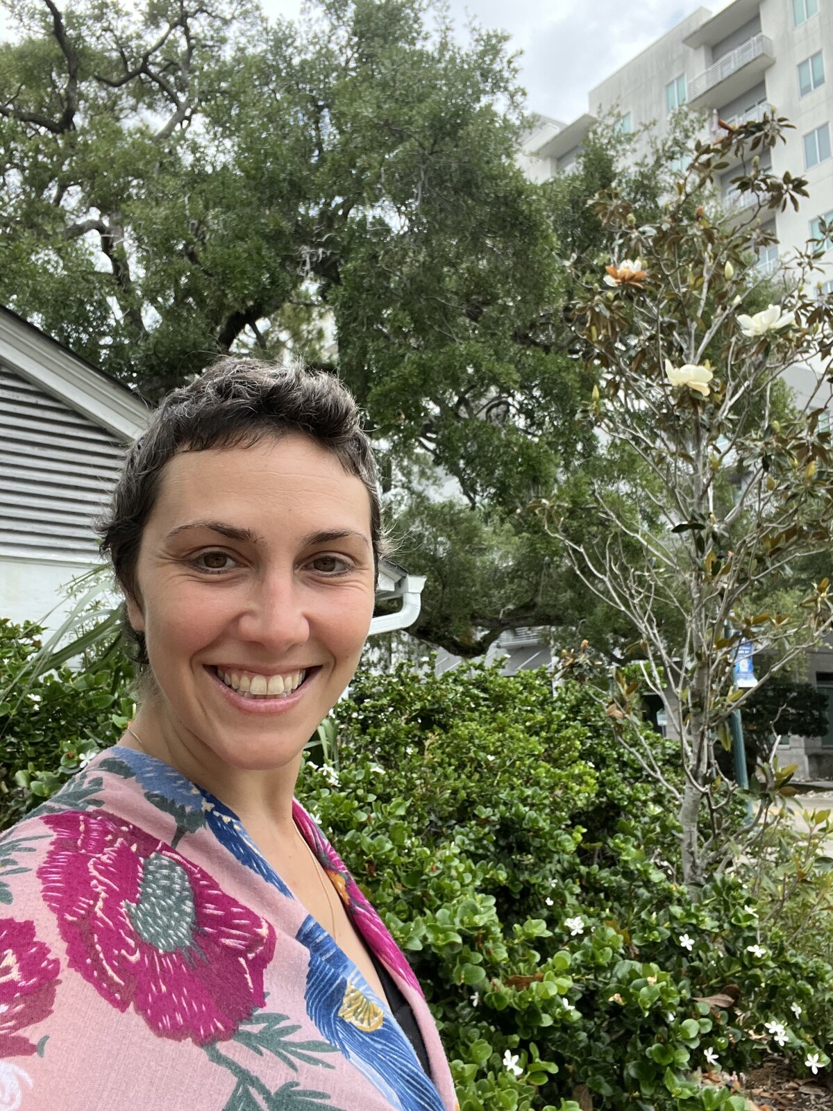 Smiling outdoors, hair grown back in, after treatment
