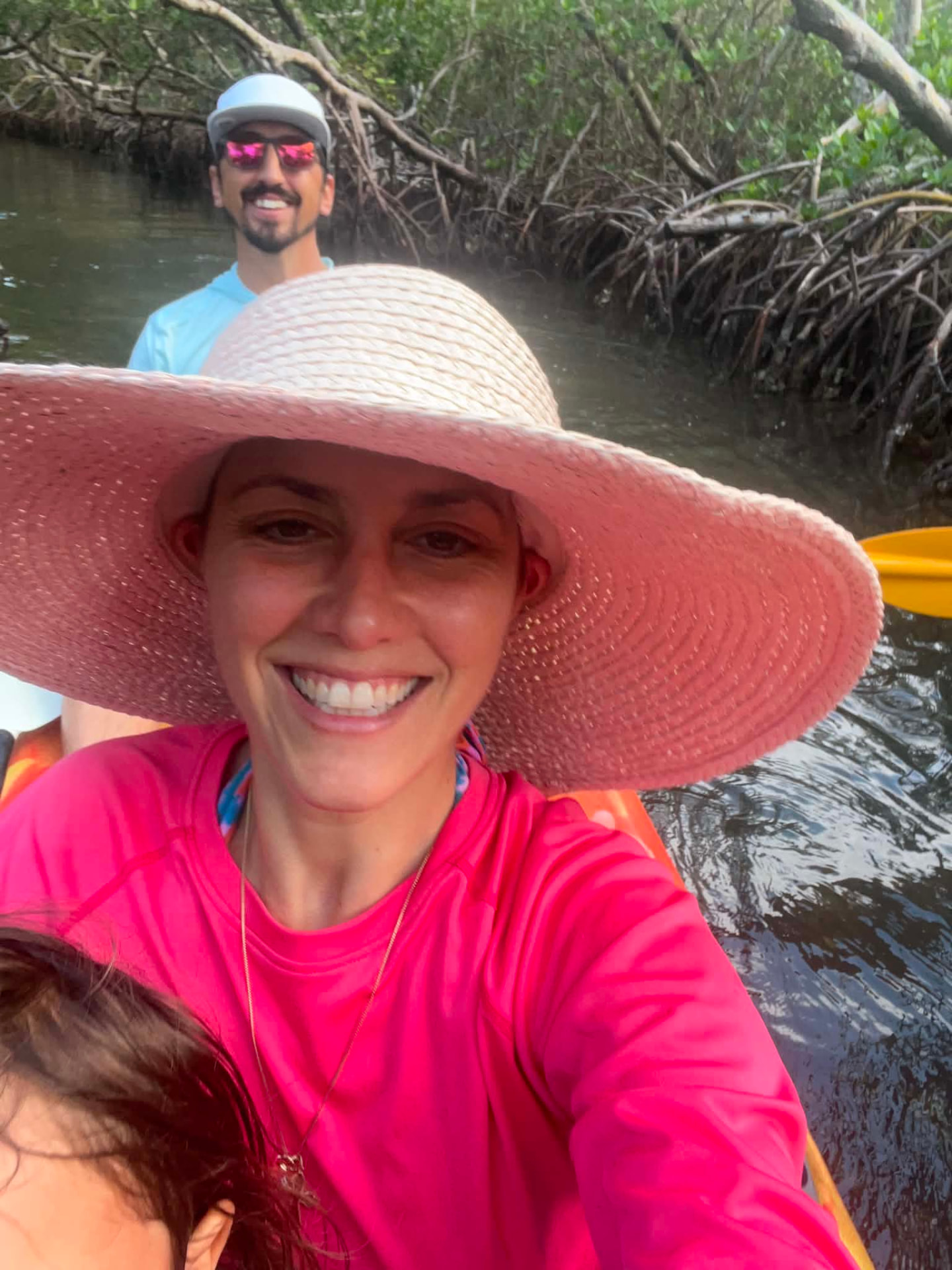 Smiling together on a kayaking trip through the mangroves